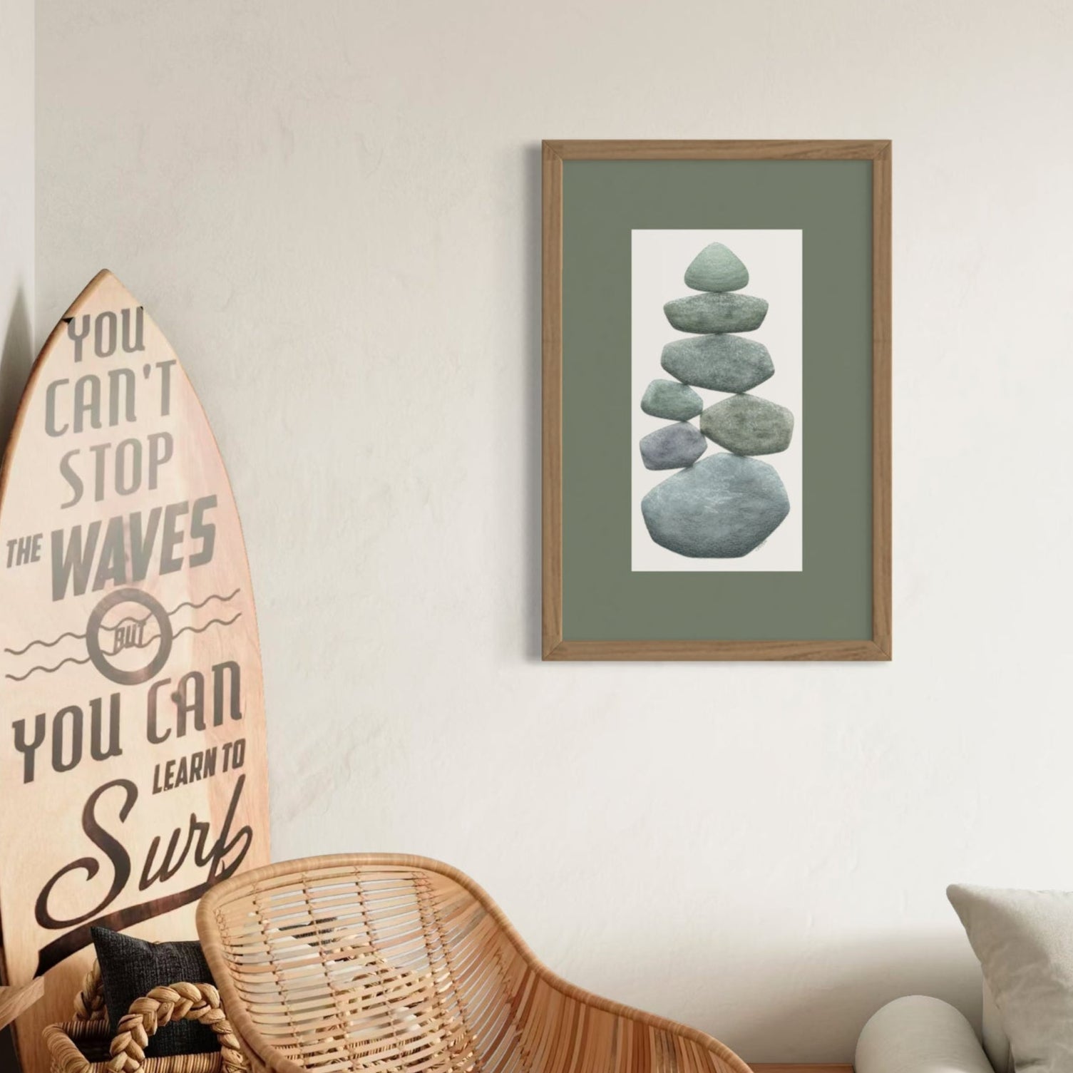 Living room with wicker chair, surfboard art, and framed pebble picture.